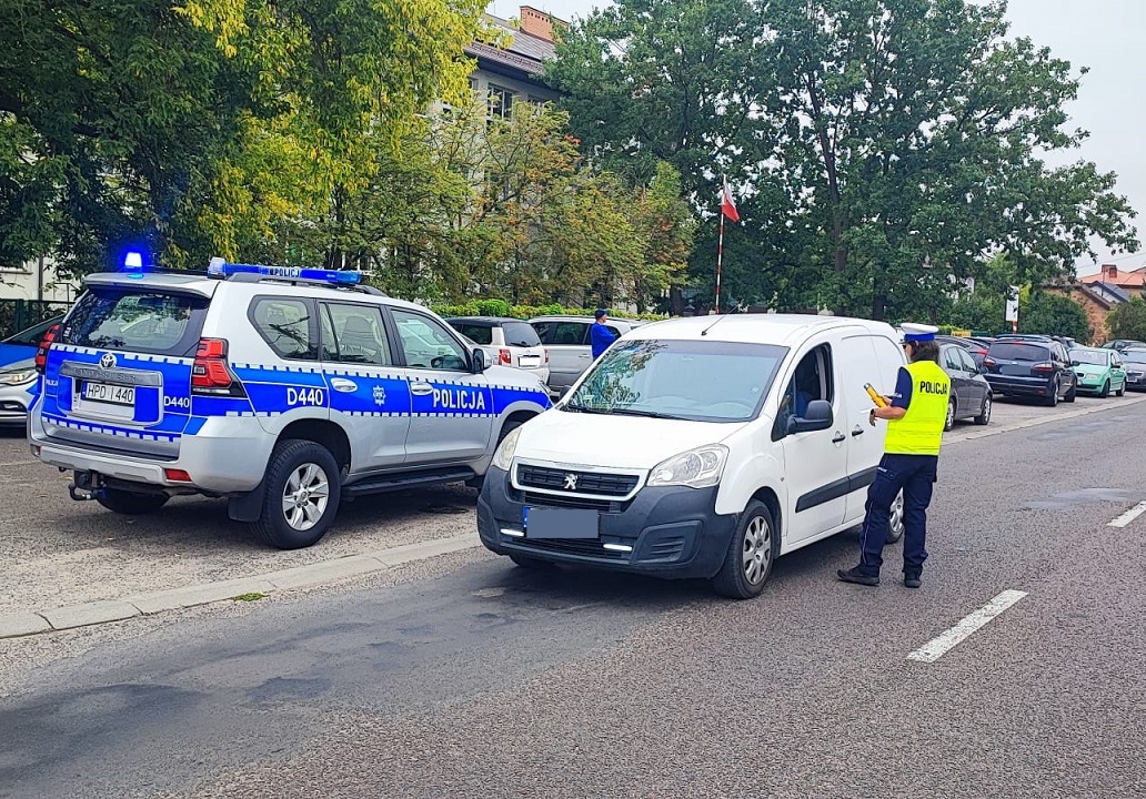 policjantka ruchu drogowego sprawdza trzeźwość kierowcy