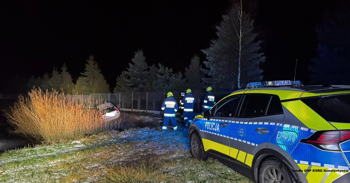 radiowóz, obok strażacy. W tle fragment samochodu przy zbiorniku wodnym fot. OSP KSRG Konstantynów