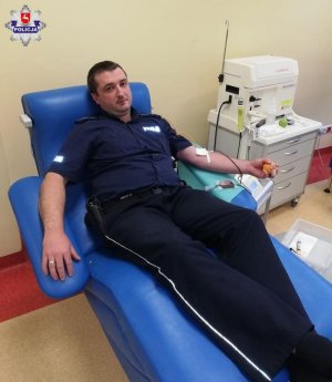 policjant podczas honorowej akcji oddawania krwi