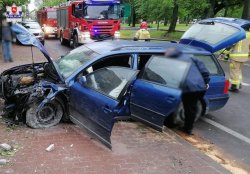miejsce zdarzenia drogowego, uszkodzony pojazd stojący częściowo na poboczu i ulicy