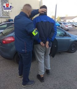 policjant doprowadzający zatrzymanego 19-latka