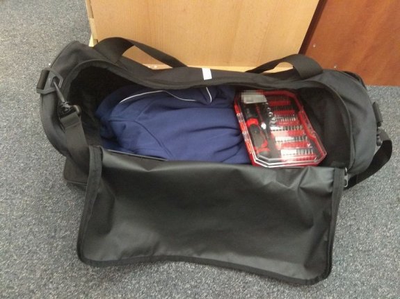 odzyskane przedmioty w tym ubrania i wkrętaki leżące w torbie podróżnej