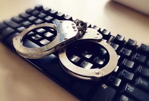 kajdanki leżące na klawiaturze komputera