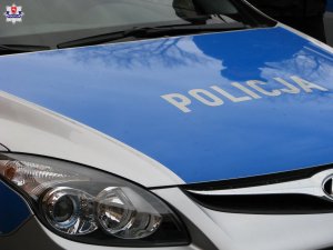 fragment radiowozu z napisem Policja