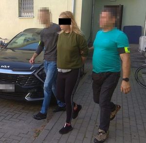 policjanci doprowadzają zatrzymaną