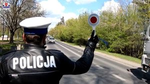 policjant Wydziału Ruchu Drogowego zatrzymuje samochód do kontroli drogowej