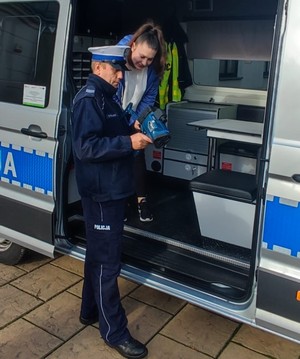 policjant ruchu drogowego prezentuje sprzęt służbowy