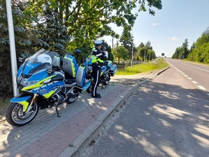 policjant ruchu drogowego stojący przy motocyklach