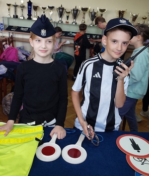 dzieci przy stoliku podczas oglądania sprzętu służbowego