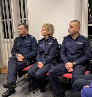 Zastępca komendanta oraz kadra kierownicza siedzą na krzesłach podczas debaty