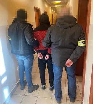 policjanci prowadzą zatrzymanego