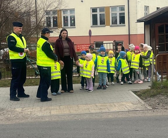 policjanci i wychowawca z dziećmi podczas praktycznej lekcji bezpieczeństwa