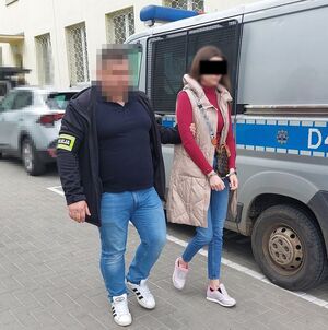 policjant prowadzi zatrzymaną