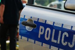 napis policja na drzwiach radiowozu